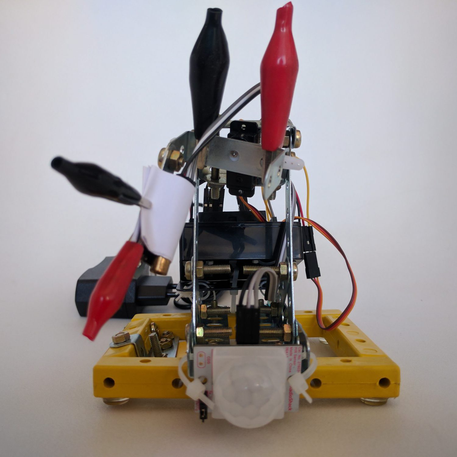 MES-1 front view. The laser pointer is attached on the left, the infrared sensor is on the center-bottom. The Arduino controller is in a black case on the back. The whole thing stays together through bolts, beams, alligator clips and plastic fasteners.